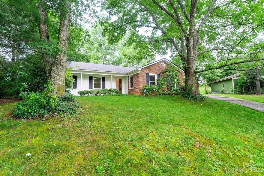 This charming one-level home is a unique opportunity in Asheville. The home features hardwood floors, new carpet in the bedrooms, & fresh paint throughout give the home a bright & airy feel. The large den with ceiling fans is perfect for a home office or playroom. The living room with gas fireplace is open to the kitchen, creating a spacious & inviting space. The eat-in kitchen has plenty of counter space & storage. The back patio is perfect for relaxing on a summer day or grilling out with friends & family. The yard is partially fenced & includes the storage shed. The primary bedroom has an en-suite bathroom with walk-in shower. The hall bathroom has a bathtub/shower, separate vanity area, linen closet. Laundry room is located in the hallway with washer and dryer hookups. This home is located in a quiet cul-de-sac, just minutes from shopping, groceries, dining, & recreation. The property is in Buncombe County tax code compatible with STRs. No HOA discovered. Buyer to confirm.