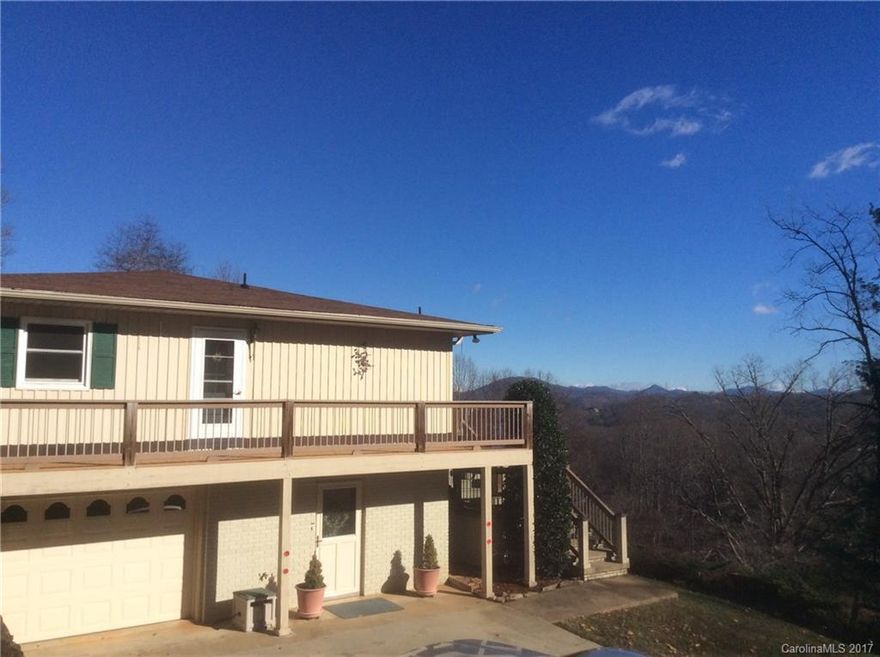 Intown Solid Home with Long Range Views - Just Waiting for you to Splash on Your Own Touch: Home Features:  Wrapping wide Trex/wood deck plus Awning, Integrated kitchen and dining area with sliding doors onto the outside patio.Three bedrooms with plenty of closets.Family Room with fireplace and laundry on main.Room To expand in the basement for workshop or recreation room, garage,new windows, heat pump, mature landscaping with peace & layered views of the mountains.Extra lot included for privacy