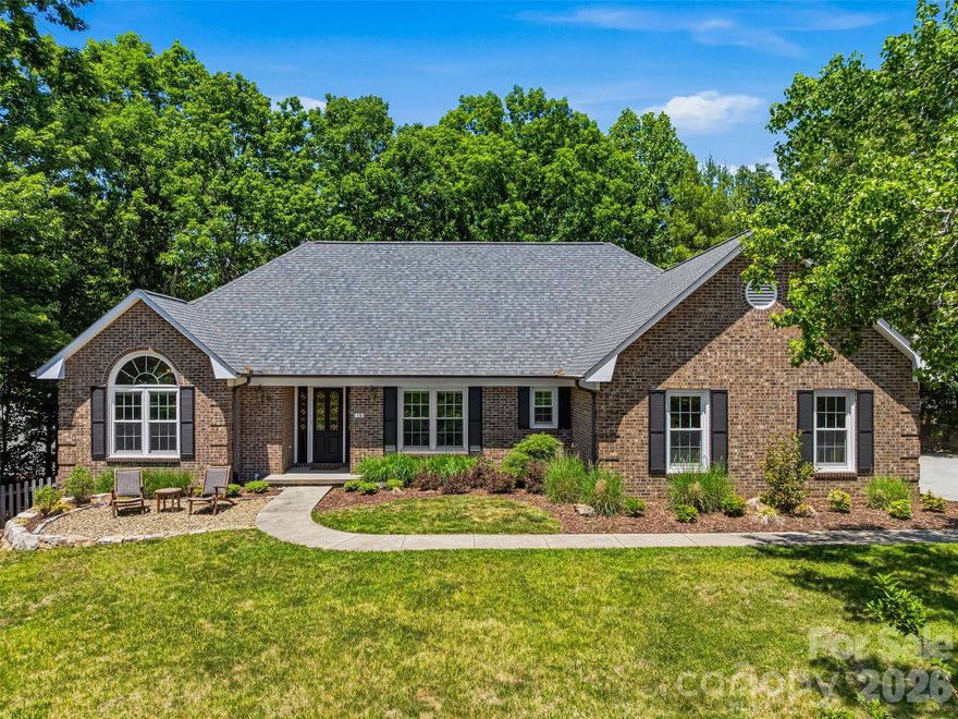 Welcome to 18 High Bluff Drive, a well-maintained home in Weaverville’s desirable Reems Creek Golf Community offering comfortable main-level living, generous indoor and outdoor spaces, and thoughtful updates throughout. The main level features vaulted ceilings in the Great Room, Primary Bedroom, Bedroom/Office, and enclosed sunroom, creating an open and inviting feel. The beautifully remodeled 2024 kitchen is a standout, featuring custom Amish cabinetry, quartz countertops, stainless appliances including a Zephyr beverage center, and a large island with sink and seating for six. Additional updates include a new roof in 2024, new white oak hardwood flooring on the upper level, and new carpet on the upper and lower levels in 2024. The main-level brick fireplace features gas logs, while the lower-level brick fireplace is wood-burning, adding warmth and character to both living areas. The lower level offers excellent flexible living space for guests, hobbies, exercise, or recreation, including a spacious family room with a large wet bar. Enjoy outdoor living from both decks, the large enclosed sunroom with vaulted ceiling, the partially fenced backyard, and the beautiful new rock garden patio in the front yard, all within a peaceful golf community setting. Optional membership at Reems Creek Golf Club offers access to golf, social activities, pool, clubhouse, and pickleball amenities. Convenient to downtown Weaverville, Reems Creek, and Asheville.  Visit https://www.reemscreekgolf.com/ for additional information.