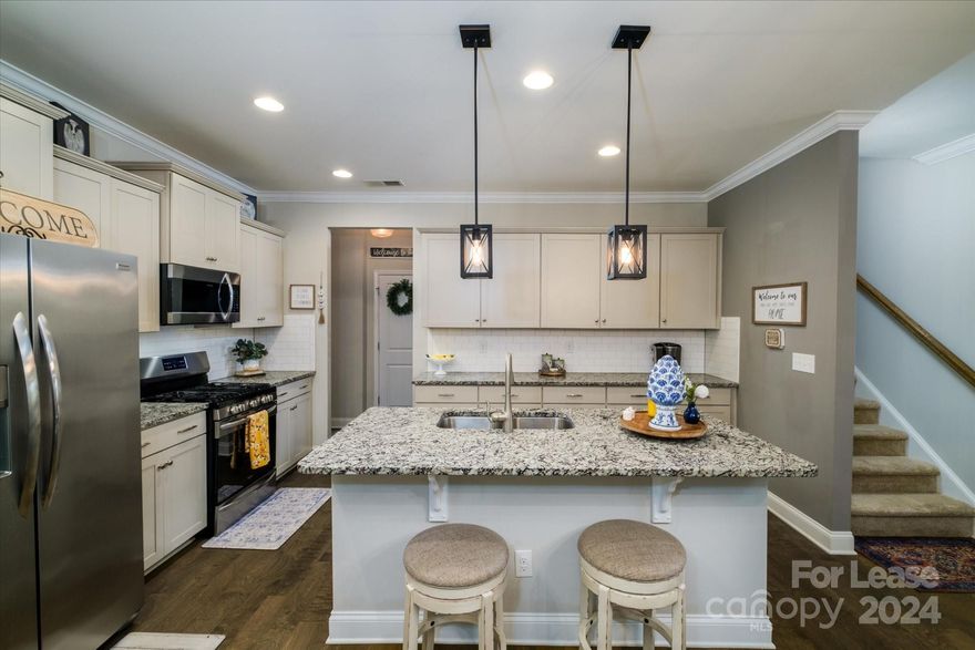 Conveniently located across from the ponds with easy access to the walking trails and the mailboxes, you have the opportunity to lease this beautiful Townhome! The main floor has an open concept throughout the common living areas with a large bedroom and full bathroom off of the living room. The kitchen features stainless steel appliances, granite countertops, and an oversized pantry. The covered back patio offers a private tranquil space that leads to the back alleyway used to access your two car garage. The second floor has an mssive loft that can be used as a second living area, kids play area, bonus area, or maybe even a man cave! The primary suite comfortably fits a king bedroom set, as well as exceptional space for a sitting area. Additionally, there's a third spacious bedroom and bathroom on the back side of the loft! This may be a townhome, but this property is larger than many of the single family homes in the area. Book your tour today!