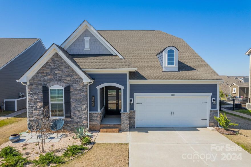 Welcome to luxurious living at 8000 Millbridge Parkway! Stunning Waxhaw residence offers an exceptional blend of elegance and comfort. Step inside to discover a spacious open floor plan flooded with natural light, perfect for entertaining or relaxation. The gourmet kitchen boasts top-of-the-line appliances and ample storage, making meal preparation a joy. Retreat to the master suite oasis featuring a sitting area, spa-like bathroom and walk-in closet. Enjoy outdoor living on the custom expansive patio with gas firepit, porch swing overlooking the beautiful and private backyard, ideal for gatherings or peaceful solitude. Additional highlights include a water filtration system for entire house, versatile bonus room, convenient main level guest suites, and a 2-car garage. Nestled in the prestigious Millbridge community, residents enjoy resort-style amenities and easy access to shopping, dining, and entertainment. Don't miss the opportunity to call this exquisite property home!