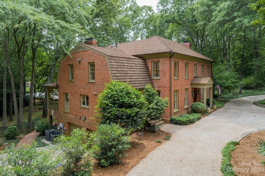 This beautiful home is the perfect blend of traditional & modern! Very functional floor plan... Large guest room with adjacent bath & separate outside entrance on main level. Split-bedroom plan upstairs with spacious primary suite on 1 side. So much value just in the land with a 1.34 acre lot, well-utilized from the landscaped front yard with C-shaped driveway to the private fenced back yard with garden shed. Outdoor living spaces galore: huge covered veranda with fireplace & TV mount, huge brick patio, fire pit, and a cozy covered back porch off the breakfast area with a covered patio below it. Partially finished basement with a 2-car garage, a huge workshop, a fitness room and a wine cellar. Additional 1-car detached garage/storage building. Tons of storage including 3rd floor leading to 2 huge walk-in attics. Other features include 4 fireplaces, drop zone, powder room, ensuite baths for all bedrooms, dual staircases, a huge bonus room and a durable new CeDUR shingle roof! Must see!