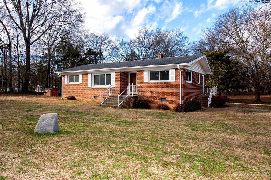 Nestled among mature trees this charming brick ranch is the investment you've been looking for.  On a half acre of land, there's room for a boat since you'll be less than one mile from the marina! Near shopping, dining, medical facilities, Ebenezer Park, Winthrop University, York Tech, and award-winning schools.  No HOA, low SC taxes, and just a quick trip from all that Charlotte has to offer.  Oversized great room, generous windows, primary bedroom with ensuite make for comfortable and cozy living.  A neutral kitchen with a charming breakfast area and lots of natural light has a new stove and tile backsplash.  Enjoy the view from the window over the kitchen sink to the huge, private, tree-lined backyard.  Utilize the private dining room as an office or 3rd bedroom with existing closet/pantry.  Well kept with a new roof, newer windows, and waiting for you to make your own! And yes, the shed stays!  Showings begin on Saturday!