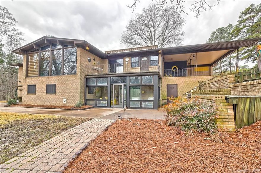 This is a rare find - Very private setting on 8 acres with a spring fed lake on property. Come home to paradise - all brick on mail floor - 3BR/2BA. Large Family Room with views of lake, Kitchen, Breakfast Area, Dining Room. Basement features open family room, bar/kitchen, 1BR/1BA, utility/sewing room, workshop, cedar closet/green house/storage/sun room - This is a very unique home. It will not last long!