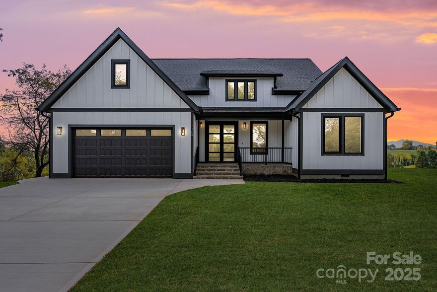 Discover refined mountain living in this brand-new custom home, ideally positioned just 12 miles from vibrant Ashevilleand 10 miles from charming Weaverville. Designed to impress, this residence blends modern luxury with the serenity of the Blue Ridge Mountains, offering both convenience and a sense of escape.

From the moment you step inside, the open-concept layout draws you in with sweeping mountain views visible from the living and dining rooms. Soaring ceilings, a dramatic floor-to-ceiling fireplace, and expansive windows flood the space with natural light and warmth. The chef’s kitchen features a walk-in pantry, premium finishes, and seamless flow into the living and dining areas—perfect for gathering and entertaining.

With two private primary suites—one featuring a spa-like bath and both offering custom built-in closets—comfort and elegance are at the forefront. Every detail has been thoughtfully curated, from the luxury finishes to the well-planned storage solutions.

Outside, a generous back deck invites you to relax, entertain, or simply take in the breathtaking long-range views. Whether sipping morning coffee or watching the sunset, this is where everyday life feels extraordinary.

Here, modern luxury meets mountain serenity—creating a place where every day feels like a getaway.