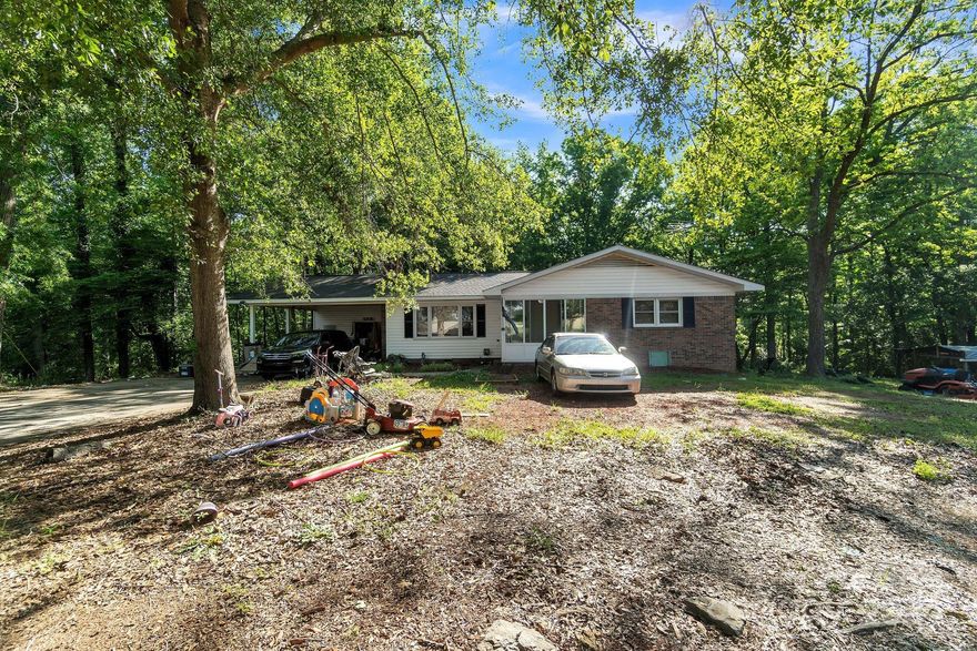 As is. Enjoy the privacy this 4.9 acre property offers! This charming 3-bedroom, 2-bathroom residence offers a serene escape from the everyday hustle. Situated on 4.9 acres of lush land adorned with a tranquil creek, Boasting 1,696 square feet of living space, this home is bathed in natural light that dances through its spacious rooms. The inviting covered sunroom beckons relaxation and enjoyment of the surrounding beauty, while ample indoor space ensures comfort for the whole family. Bring your vision and personal touch to this home and make it your own!