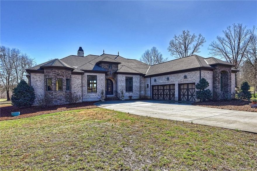Exquisite custom brick & stone home on 2 acres w/ gorgeous tile work, marble & granite throughout! Custom ceiling details, custom built closets, lovely arches & mill work, a cook's dream kitchen w/ss GE Monogram appl., huge breakfast bar, & custom cabinetry. Super high ceilings highlight the open floor plan & gas fireplace w/ marble & tile surround from floor to ceiling. Master w/ dual closets, glass block walk-in shower, & jetted tub.  Wet bar, covered porch, patio, fruit trees and more!