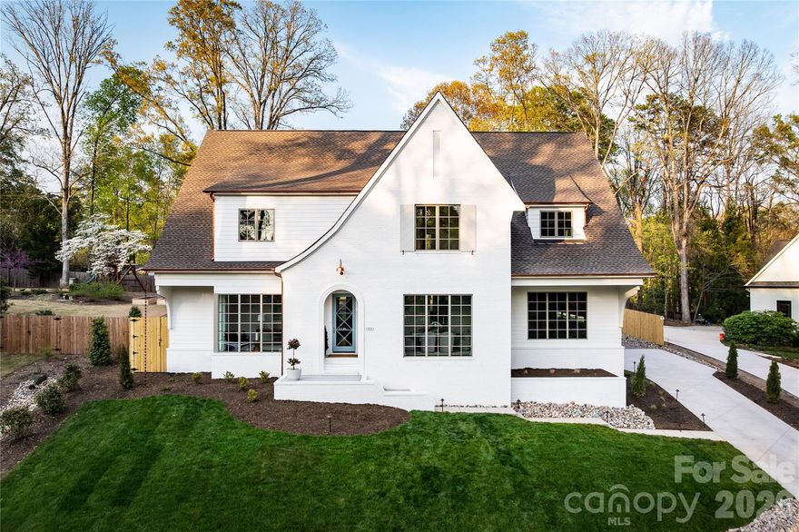 Welcome to this exceptional new construction home by Springdale Custom Builders, thoughtfully positioned at the end of Hunter Lane in Sherwood Forest - one of South Charlotte’s most established and sought-after neighborhoods. Offering convenient access to Uptown, SouthPark, South Charlotte, and the region’s premier hospital systems, this residence pairs location with an uncompromising level of design and craftsmanship.

Set on a private lot, this 4,798+ square foot home is a showcase of refined living, where every element has been intentionally selected and meticulously executed. From the moment you arrive, the architectural presence is undeniable, highlighted by copper gutters, a custom rain chain, designer copper lighting, and custom oversized corbels - distinctive exterior details that signal the level of quality carried throughout the home.

Inside, the layout is both highly functional and beautifully composed, designed to support everyday living while elevating the experience of entertaining. The home features five bedrooms, four full bathrooms, and a powder room, along with a dedicated office, screened-in porch, and a spacious recreation room with wet bar. Each space flows naturally into the next, creating a cohesive and comfortable environment.

At the heart of the home, the kitchen is as practical as it is striking - anchored by an oversized island and complemented by a decorative slab backsplash that creates a clean, elevated focal point. A fully equipped scullery and butler’s pantry provide additional function, with the scullery featuring a second dishwasher, full-size refrigerator, and a large fluted farmhouse sink - ideal for seamless entertaining. Custom cabinetry is thoughtfully integrated throughout the home, paired with detailed millwork that adds depth and character. In the kitchen, scullery, and butler’s pantry, brass cabinet hardware sourced from England introduces a refined, bespoke finish.

Site-finished oak hardwood floors extend throughout, reinforcing the home’s warmth and craftsmanship. The open-concept living area centers around a limestone-surround fireplace with custom built-ins and picture lighting, creating a refined focal point while maintaining a relaxed, livable feel. Large openings lead seamlessly to the screened-in porch, where a dedicated fireplace creates an inviting, year-round outdoor living space.

The dining room and private office are positioned for both functionality and visual impact, each featuring dramatic 8-foot windows that extend to the floor, filling the spaces with natural light and enhancing the home’s architectural presence.

The main-level primary suite is designed as a true retreat, offering privacy, scale, and thoughtful detail. Vaulted ceilings create an airy, elevated feel, while the ensuite bath features custom cabinetry with reeded doors and drawers, bringing a tailored, furniture-quality aesthetic. A zero-entry walk-in shower with a striking tile design completes the space, delivering both luxury and ease of use.

Upstairs, four additional bedrooms and three full bathrooms provide ample space for family and guests. Each bathroom has been individually designed with unique, high-end finishes - ensuring that no space feels secondary. An oversized bonus room offers exceptional flexibility, easily functioning as a media room, fitness space, additional bedroom, second office, or creative studio, complete with a wet bar to support any use.

Every detail of this home reflects Springdale Custom Builders’ commitment to quality, design integrity, and livability. This is not simply a new construction home - it’s a carefully curated living experience in one of Charlotte’s most desirable locations.

Showings begin March 28.