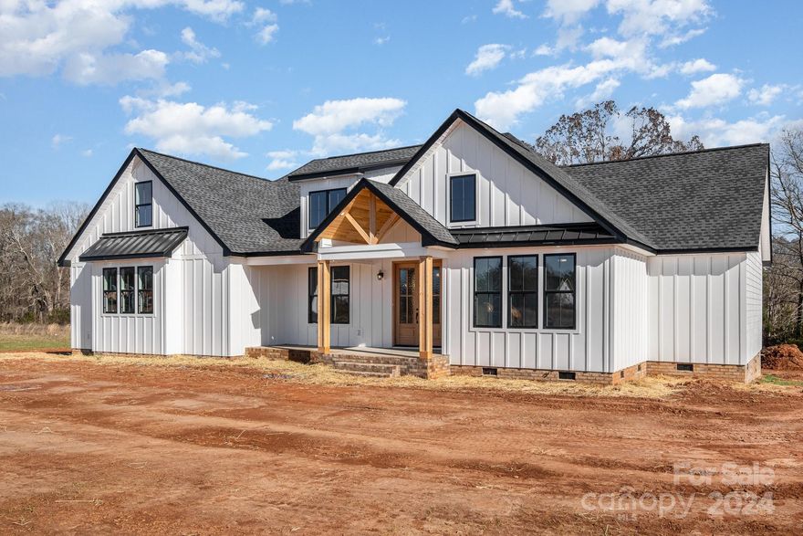 Introducing this spacious new construction home in Sanders Landing. This beautiful home features an open floorplan with the kitchen, living, and dining area splitting the bedrooms. Kitchen has island with seating, custom range hood and huge walk-in pantry. Enjoy the craftsmanship with the shiplap on fireplace, coffered ceiling, wall sconces, wainscotting throughout and vaulted ceiling in living room. Primary bathroom features dual vanities, soaking tub, and custom tile shower including dual shower heads and a rain head. Primary also has his and hers walk in closets with built ins already installed. Primary closet attaches to laundry room so life is just a tad bit easier! Covered front and rear porch with cedar ceilings make this the perfect spot for entertaining! Don't miss this opportunity! Photos are renderings/representative & some details will differ. Options, colors, etc in MLS may change during construction, and may differ from completed final property.