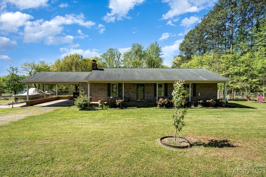 Welcome to a retreat away from the world. This fully updated brick ranch sits on a private 2.59 acres (two plots). The home was just updated with a fully remolded kitchen, new flooring, new paint and updated bathrooms with full tile showers. Three nice sized bedrooms with the primary bedroom in the back of the home. Fully fenced yard with a new deck off the back of the home for easy entertaining overlooks the inground pool with a second fence for extra security. The back of the lot is tree lined for hiking or check out the separate 3 bay garage for working & creating anything you can dream of. The oversized 2 carport enters in through the mudroom, laundry. Your pet will love the doggie wash area off the carport so the dirt stays outdoors. 
Come see this gem today! AND There NO HOA !