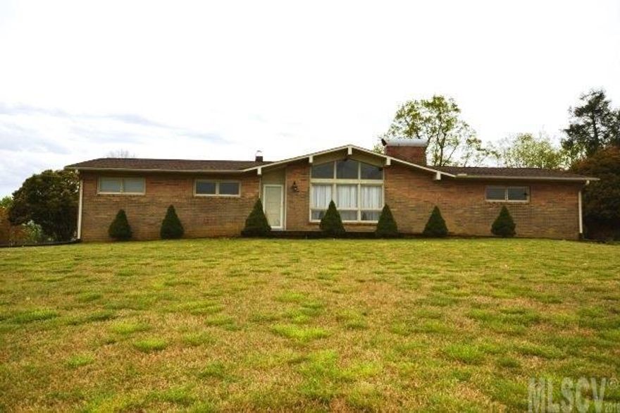 Perched up on a hill with mountain views, this 3 bedroom, 2 bath brick ranch is a great find! There is a huge den, living room with cathedral ceiling and fireplace, roof is only 4 years old, new cooktop, vinyl trimmed eves, and freshly painted interior, as well as freshly painted exterior trim. There is a second fireplace in the full unfinished basement. The home sits on a large 1.41 acre lot with plenty of space for gardening, pets, etc.