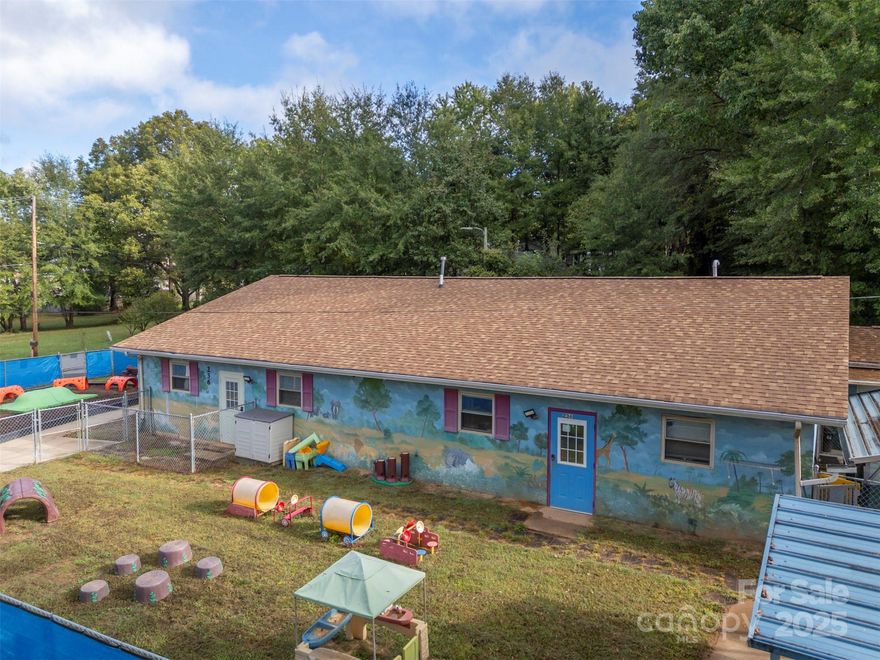 Turn-Key Daycare Facility in the Heart of Spindale! Don’t miss this incredible opportunity to own a fully equipped, turn-key daycare facility just steps from downtown Spindale! This well-maintained property comes furnished and ready for business — simply open the doors and start welcoming families. The building features a small admin office upon entry, four classrooms, two bathrooms for children and one for staff, and a fully equipped kitchen ready for meal prep. A dedicated laundry room includes a washer, dryer, and extra storage for supplies. Outside, you’ll find four separate playgrounds, each safely fenced and designed for different age groups — including one covered play area perfect for rainy days. A paved parking lot with 10 spaces ensures convenient drop-off and pickup, and security equipment is already in place for peace of mind. Sitting on a 0.33-acre lot, this property offers a prime location within walking distance to downtown Spindale, the Rails to Trails, restaurants, and local amenities. Whether you’re looking to launch a new childcare center or expand an existing one, this move-in ready facility provides the perfect setup to hit the ground running!