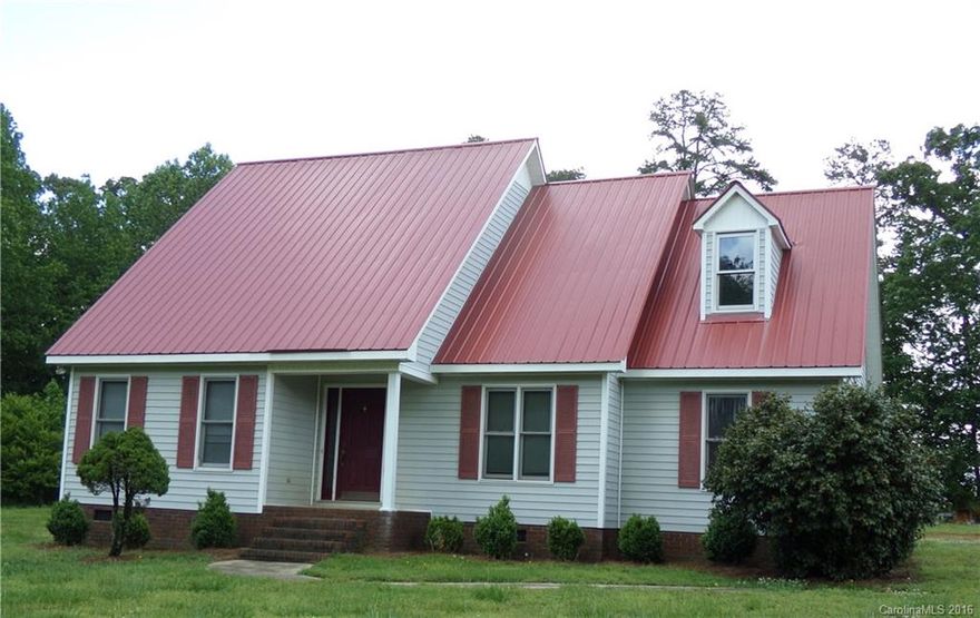 Don't miss this spacious house located close to the NC/SC line.  First floor features a living room, dining room, kitchen with vaulted ceiling, sunroom with fireplace and new flooring, bedroom and bathroom/laundry.  The second floor features an open view walkway of the first floor and has two bedrooms and one full bathroom.  There is plenty of storage in the three bay open shed and storage building.  Make this house your home with some updates.