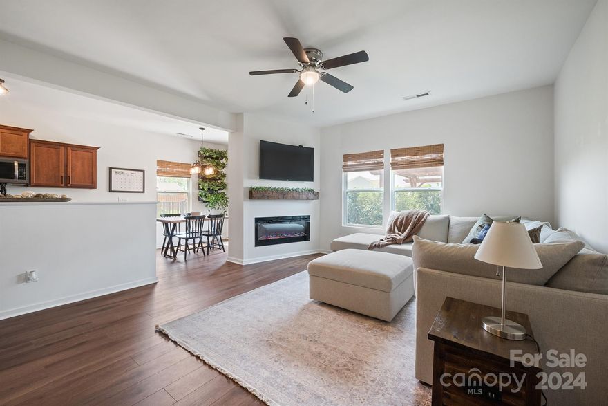 Welcome to this better than new, Move-in ready 3 BR, 2.5 BA home in desirable Hidden Lakes Subdivision. New carpet installed 9-26-24. The Living Room flows to the kitchen and dining area in this open floor plan.  The LR has a Built-in Electric fireplace and beautiful reclaimed wood mantle perfect for displaying those treasured photos or decorating for Holidays. Downstairs and Baths have new LVP flooring. Kitchen has matching LG black Stainless Steel appliances. There's upgraded light fixtures throughout. Dining area has custom, Built-in hutch with solid wood shelves. The backyard offers plenty of room for entertaining, a Large extended patio and walkway, Pergola, and 4 foot aluminum fence with upgraded gate. You'll enjoy the short walk to the community pool on those hot summer days. Conveniently located just minutes from Troutman and Statesville's downtown area and I-77. All appliances remain including Refrigerator and washer & dryer. Make this beautiful home yours before the holidays!