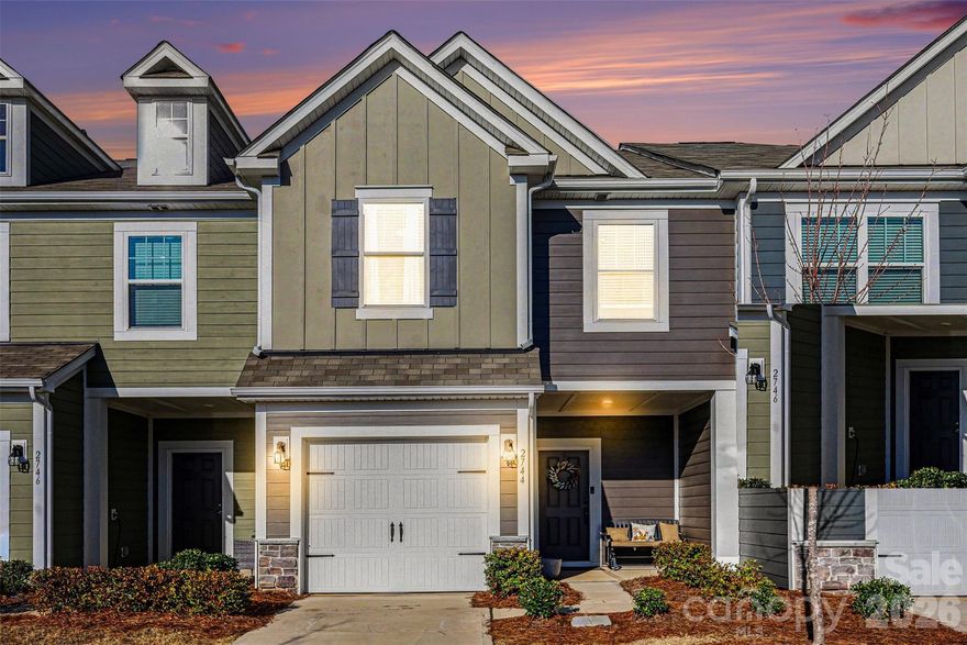 Enter this home through the inviting covered porch and step into a bright, open floor plan. The kitchen is designed for both function and style, featuring a large island with a sink, a gas range, a built-in microwave, and a convenient pantry. Granite countertops and the gas range add both elegance and practicality. Just off the kitchen is the dining area, creating a seamless flow for everyday living and entertaining.  The living room is anchored by a custom fireplace with a beadboard backdrop and a rustic wood mantel, creating a warm focal point for the space. 
Upstairs, the spacious primary suite features a tray ceiling and a custom closet organizer in the walk-in closet. The ensuite bath includes a dual-cabinet vanity, a separate shower, tile flooring, and a private wet area. The secondary bedrooms are generously sized and feature neutral carpeting. The secondary bathroom offers a single-sink vanity and a shower/tub combination. Outside, enjoy the patio with privacy dividers that overlooks a peaceful, tree-lined area.

.