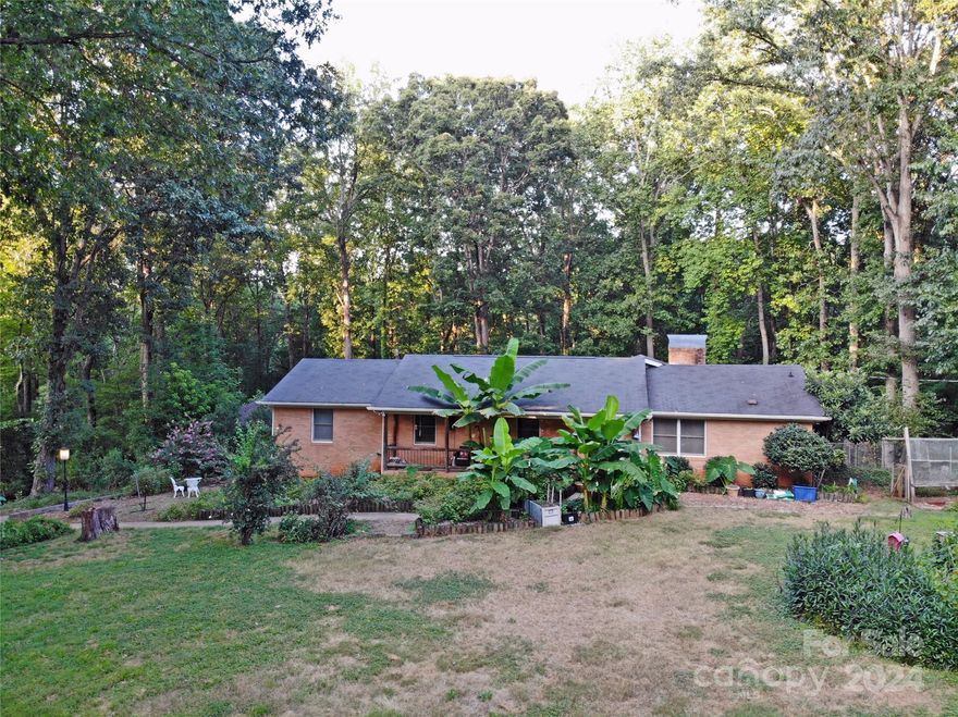 Are you looking for country feel but only 20 minutes from Charlotte? Well then this is the house for you. Situated in an established neighborhood in the Mint Hill area on a 1.97 acre lot. This full brick home features 3 bedrooms and 3, yes 3, full baths. It also features a partially finished basement that has spaces used as a hair salon, exercise room and family room. The unfinished side has the air handler and an area that would make storage for your canned vegetables you get from the garden on site. There is also a work/tool space. Outside is a fenced in back yard and plenty of trees and shade that gives it that country feel. In the backyard the is rock steps leading down to the rock fire pit area with a natural carved log bench to sit on and enjoy the outdoors. Out back there is also carport structure just off the concrete drive. This property is just minutes from 485 and just down the road from Mint Hill founders Park. Selling as is. Come see this slice of country near the city.