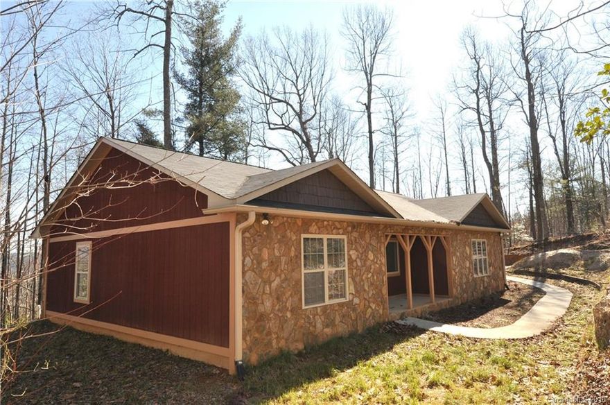 The price on this friendly ranch just dropped thousands. You can recognize instant equity in this property priced below tax assessment!  Stone fireplace in the Living Room wired for your media center, master BR with 2 walk-in closets, split BR plan.  Efficient kitchen, dining area, laundry room off the two car garage.  Very private location with a wooded backdrop.