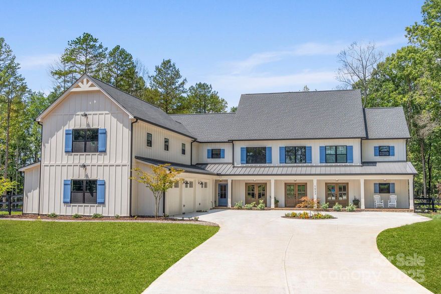 Welcome Home!!  This luxurious Estate is tucked at the end of a winding quarter-mile driveway that weaves through mature carolina hardwoods and vibrant seasonal foliage, this custom country estate home
offers a striking first impression that carries through every detail of the build.
The home is built and accented with timeworn reclaimed and locally sourced
timber, oak, brick and stone that give the structure its strength and soul. 
Inside, the chefs kitchen is the heart of the home, anchored by massive 8x8 reclaimed
timbers in a truss-style ceiling, set against a backdrop of oak nickel gap for a cozy,
layered feel.  Z-line appliances with a 48 inch gas range.  Many extra touches featuring hand-hewn timbers from centuries past were used for the newel posts, with locally reclaimed oak crafted into the handrails.
Around the kitchens oversized picture window, more hand-hewn framing ties the craftsmanship
together, blurring the line between past and present. At the center of the living
space, a natural stone fireplace adds warmth and texture, pulling in the same rugged
elegance found throughout the design.
The home features a half court indoor basketball/pickelball court, oversized saltwater pool with jacuzzi and grotto.   Outdoor putting green, detached workshop/garage.  Everything you need for entertaining.
For added protection a safe room was built into the primary bedroom for your family extra security.
Office upstairs can be used as a 6th bedroom, but septic permit is for 5 bedroom.
Zoned for new Lake Wylie High School
