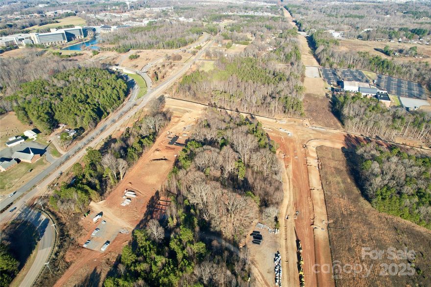 Prime Development Opportunity on almost 3 acres off of Langtree Road, Mooresville, NC. This property is zoned Corridor Mixed-Use (CM), offering immense flexibility for a range of uses, including multifamily housing, retail, and office developments. Situated directly across from Lowe’s Home Improvement’s corporate headquarters, a sprawling 275-acre campus developed to house up to 10,000 employees, providing a built-in market for future development. Adjacent to the upcoming East-West Connector Road, currently under development, which will further enhance accessibility and traffic flow in the area. Completion date Q3 2026 Easily accessible to I-77 at Exit 31