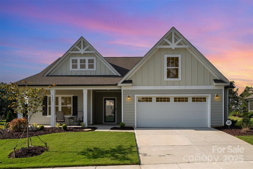 Fully custom golf course home on a private 1/2 acre home site! This stunning 3-bedroom, 2-bath single story home offers modern living in one of the Carolinas’ premier golf communities. Overlooking the 17th green and 18th fairway of the Carolinas' Top 100–ranked Stonebridge Golf Course, the home enjoys a southern-facing rear view and access to resort-style amenities including a pool and cabana, pickleball and tennis courts, and a fitness center. Inside, the thoughtfully designed floor plan is elevated with custom features throughout. The great room and kitchen showcase soaring 11’ coffered ceilings with recessed lighting, while the sunroom and extended dining area create the ideal spaces for both relaxation and entertaining. The chef’s kitchen features upgraded Lusso quartz countertops, 42” soft-close cabinetry with roll-out drawers, a stainless steel farm sink, under-cabinet lighting, and Frigidaire Professional appliances—including a gas oven. Retreat to the spacious primary suite, complete with a sitting room and a luxurious spa-like bathroom featuring large-format tile, premium cabinetry, and upgraded fixtures. Additional highlights include upgraded Pergo sustainable wood laminate flooring, wainscoting in the foyer, 8” baseboards, and whole-home custom blinds. Outdoor living is equally impressive with over 750 sq. ft. of extended patio space finished with concrete, tile, and pavers—perfect for enjoying tree-lined backyard views. Professional landscaping with expanded flower beds and a drip system enhances curb appeal, while Anderson storm doors, luxury lighting and ceiling fans, pre-wired audio, and a security system with video cameras ensure comfort and peace of mind. Practical upgrades include a garage bump-out with EV charger pre-wire, an enhanced HVAC system with high-performance filtration, and Sherwin Williams washable paint throughout the home. This is more than just a home—it’s a lifestyle, offering modern elegance, community amenities, and breathtaking views in one of the Carolinas’ most sought-after golf communities! Roughly 10 minutes to downtown Waxhaw where you can enjoy endless events, shopping and restaurants!