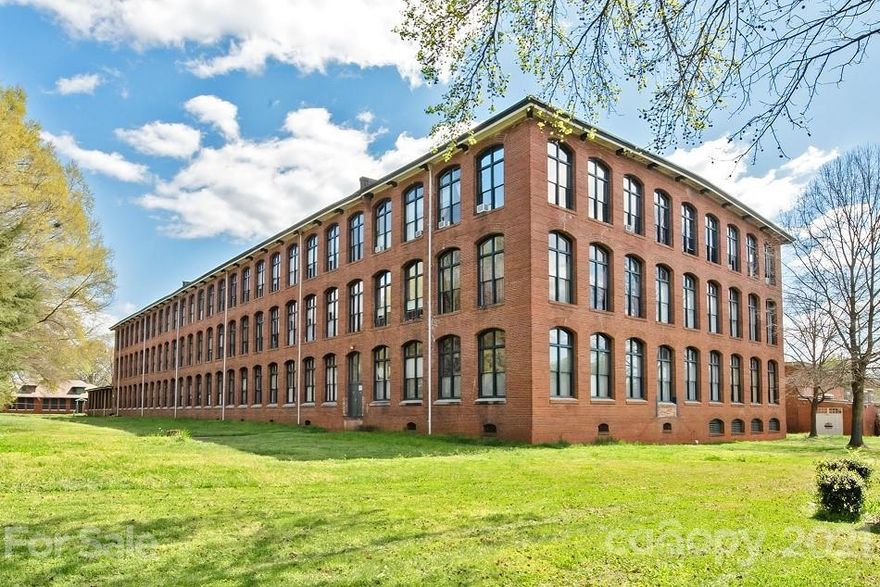 Beautiful, light filled loft in Historic Hoskins Mill. This third floor unit in one of Charlotte's limited "true" converted mills features exposed brick walls, pine timber beams, 17' ceilings, large 12' windows with brick arches, and stainless steel appliances. Updates to this two bedroom unit include kitchen cabinets with tile backsplash and butcher block counters, laminate wood floors in bedrooms, tile in bathroom, and a new water heater (2020). In addition, the building includes an elevator, community patio, and secured building entry. Easy access to interstates and close to Uptown.