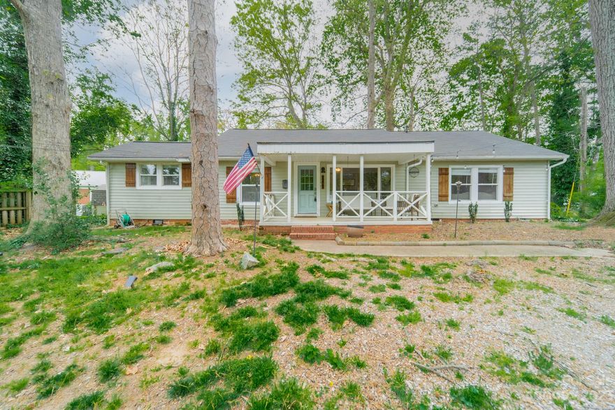 Location, Location, Location..10 min drive to Uptown! Oakhurst on Monroe Shopping and Common Market right around the corner. Neighborhood is booming with new construction. Move-in ready, renovate or build your dream home on this large, flat, private and beautiful usable lot. Grab your favorite drink, sit on the front porch or the back patio and enjoy the surroundings. Kitchen has been updated with new tile floors, granite countertops, stainless steel dishwasher, electric cooktop/oven and plenty of cabinet space.
Separate dining area and large living room to kick back and relax. Split bedroom floor plan allows for lots of privacy. Huge primary bedroom with walk-in closet and renovated bathroom. Two large additional bedrooms with large closets and second full bath. Large laundry room with plenty of storage space. Home is set away from the street with a long driveway and tons of parking available. New roof and HVAC IN 2017. Tons of parks nearby and access to three Greenways.