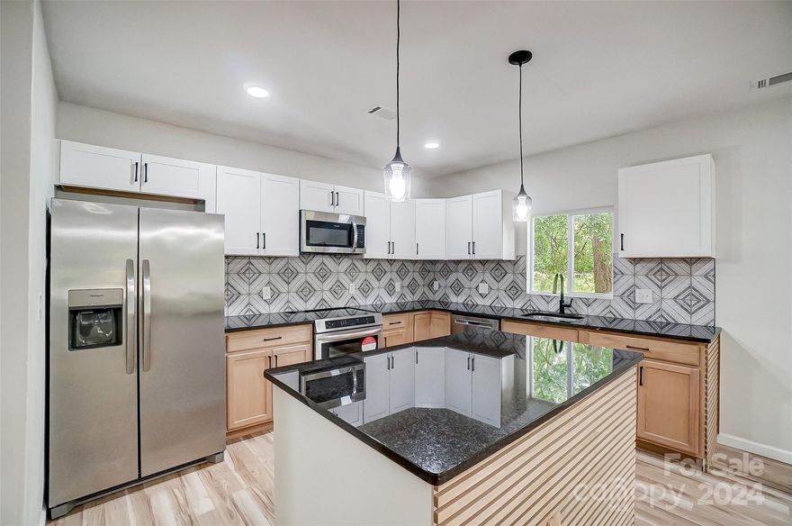 A MUST SEE! The only 4 bedroom available in the neighborhood and at a super low price per square foot! Qualifies for NC Down Payment Assistance for first time home buyers, as well as USDA so no down payment needed! Want to own one of the largest homes in the neighborhood?! Custom staircase leads you to the primary suite which is the ENTIRE TOP FLOOR w/ full bathroom & huge room-size walk-in closet. Main level has an open floorplan w/ 3 additional bedrooms (or make one a formal dining room)! LVP flooring throughout, custom fireplace w/ color-changing insert, stainless steel appliances, and spacious kitchen & dining area with large custom island, complete w/ acoustic paneling. Other upgrades include granite countertops, NEW roof, NEW plumbing, upgraded electric, & NEW HVAC. Huge, covered front porch waiting for your rocking chairs! Growing neighborhood with lots of new construction. Minutes from downtown Shelby. Easy commute to Charlotte!