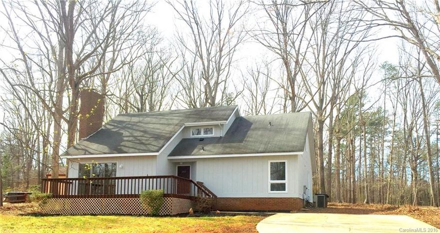 Beautiful wooded lot with deck and large porch area.  HVAC only 2 years old! Two bedrooms down and two additional with bonus/loft with closet up! Wonderful vaulted ceilings, loft, deck and porch. New flooring, carpet and paint. Lovely community lake nearby! Buyers terminated after DD, back on market