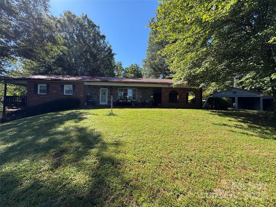 HAPPY VALLEY! 3 Bedroom, 2 Bath Brick Ranch on 1.5 +/- Acres! Several buildings, garages/shops, etc  also on the property. The main garage has 2 garage doors and can hold up to 5 cars, with a walk in door, oil pit, compressed air line all around, half bath, propane heat and wood wood stove.Upper garage door is sandblasting room with ventilator and fan. Lower garage has floor anchors. All buildings have electricity. The barn has 3 rooms, one upstairs, two down stairs and a garage door. This listing is an estate and subject to 3rd party approval.