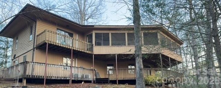 Large home on 7 acres close to Lake Lure NC. The floorplan features an expansive main living area with open kitchen/dining/living space. A very unique fireplace is the central focal point of the room. The entire rear of the home is flanked by a screened in deck. 2 master suites on the main level and a centrally located half bath, all surrounded by windows and sliders create a picturesque living space. the kitchen has stone tops and SS appliances. Full finished basement with separate entrance offers unlimited possibilities and it also has a full kitchen, multiple living spaces, and a full bathroom. There is manufactured home with addition also on property that could be a 2nd residence. Also a detached dbl garage and workshop. All this and so very close to Lake Lure, home of the iconic film Dirty Dancing, which is still celebrated locally by a yearly Dirty Dancing Festival! Dont miss this rare opportunity!  Property sold AS-IS with all faults. Seller is unaware of the condition of the Property. Seller makes no warranties, expressed or implied, as to the condition of the Property or the presence of any hazardous substances.