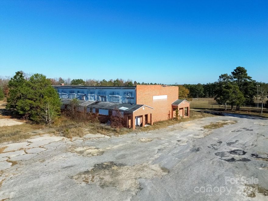 Property on highly traveled 903, lots of exposure for your future business. 2 structures on property. One was previously a school gym and one was a cafeteria. The cafeteria has a fairly new roof. Opportunity awaits on these 5 acres.