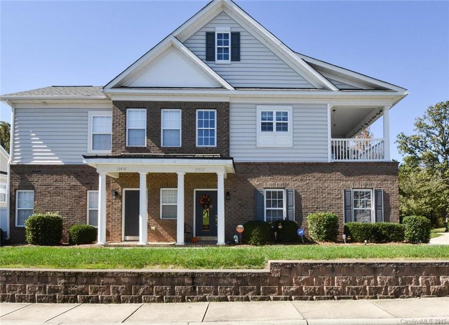 Exceptional townhouse with fabulous Ballantyne location!  This popular floorplan features transitional layout with clean lines, vaulted ceilings, and picture windows that bring in plenty of natural light.  The large kitchen features granite countertops with under-mount sink, upgraded cabinets, tile backsplash, and center island.  Hardwood floors throughout main living area.  This end corner unit also has 1-car garage and covered balcony!