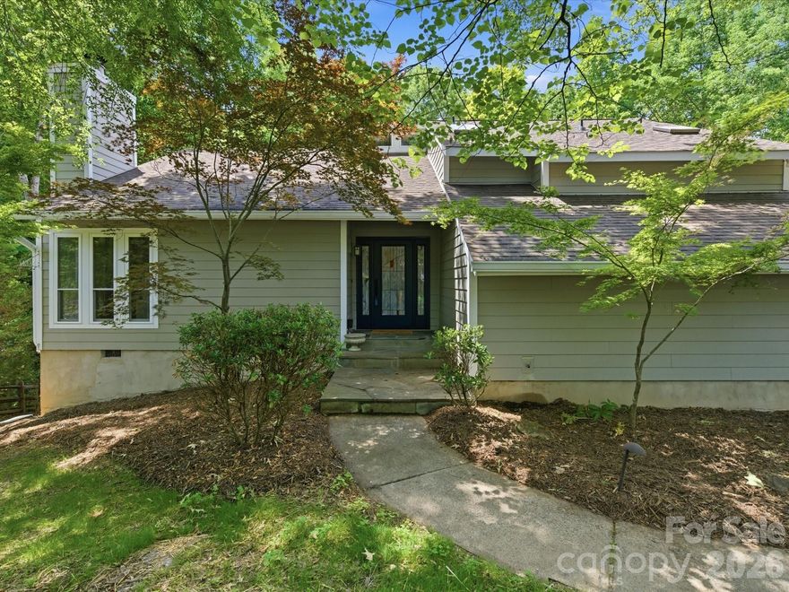 Tucked away on 1.44 wooded acres in a prime Charlotte location, this one-of-a-kind tri-level retreat offers a rare blend of architectural character, privacy, and modern updates. Surrounded by mature trees and natural landscape, the setting feels more like a mountain escape than a city address, yet is ideally situated next to McAlpine Creek Greenway, just minutes from SouthPark Mall and The Arboretum Shopping Center, and approximately 20 minutes to Uptown Charlotte.

At the center of the home, the gourmet kitchen is designed for both function and statement, featuring a six-burner range, custom exhaust hood, Thermador double ovens, Sub-Zero 48-inch refrigerator, maple cabinetry, and concrete countertops. Rich wood detailing and updated maple hardwood flooring throughout all three levels add warmth and continuity. The main living area is anchored by a stunning floor-to-ceiling stone gas log fireplace, creating a warm and dramatic focal point.

The true showpiece is the architect-designed, timber-framed screened porch and wraparound balcony, creating a breathtaking treetop experience. With Brazilian hardwood flooring, cable railings, infrared heaters, and built-in Bose speakers, this award-winning space seamlessly extends the home outdoors and offers year-round enjoyment.

The primary suite is filled with natural light and includes a sunroom retreat with bamboo flooring and updated windows, along with a fully renovated primary bath completed within the past year. Additional living space includes a walk-in wine cellar and a flexible fourth bedroom ideal for a home office, bonus room, or guest space.
Extensive updates provide peace of mind, including a new roof in 2024, HVAC replacement in 2019, water heater and garage doors in 2022, and updated siding, windows, and doors in 2015. Fresh interior paint, updated gutters with guards, and recent exterior improvements further enhance the home. See the list of features / updates in MLS attachments from agent. 
The property also features a poured concrete retaining wall, aluminum fencing, and underground drainage routed to a cistern for water management.
This is a rare opportunity to own a home that offers privacy, design, and character in one of Charlotte’s most desirable and convenient locations.