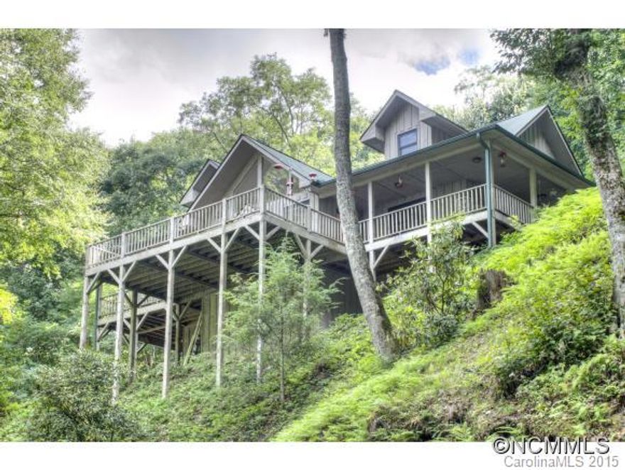 You can not get much closer to living on the Blue Ridge Parkway! Private, corner lot with a rushing stream/waterfalls just outside Maggie Valley. Home offers a nice airy floor plan with lots of windows/glass, vaulted ceilings, & open living spaces. 2 bedrooms on main, 1 above with bath, & a  loft & bonus room for office/sleeping. Huge deck spaces (some covered) to listen and watch the water flow. 2 car garage in unfinished basement & storage. Being sold with most furnishings!