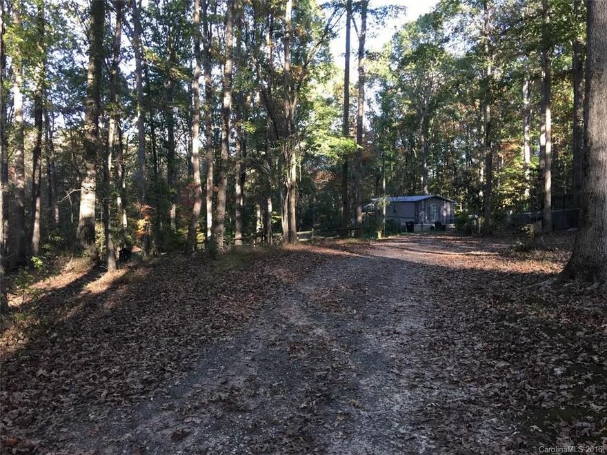 Sitting on approximately one acre of wooded land, this single wide mobile home features a fenced in yard, private well, and septic system. Sit under the shade of the mature trees and enjoy your morning cup of coffee overlooking nature while the sun rises. The split bedroom plan offers a master bedroom with double closets, and a private master bathroom. Make this yours just in time to watch the leaves fall!