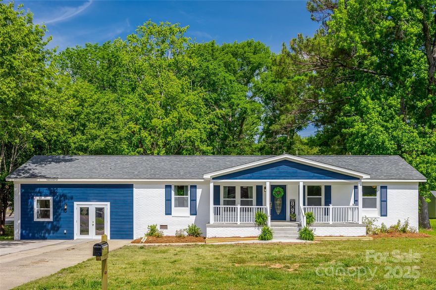 This beautifully updated ranch home blends modern comfort with classic charm. Located on a corner lot in Rock Hill, it features a new roof, new HVAC, and all permitted renovations. Inside, enjoy an open floor plan with stylish vinyl plank and tile flooring throughout. The home offers 4 bedrooms and 3 full baths, including a lower-level suite with barn doors and wrought iron railing. Bathrooms showcase elegant tile backsplashes and gold rainforest shower heads. The chef’s kitchen boasts navy cabinets, stainless steel appliances, and a sleek hood over a Whirlpool oven. Staged as 3 beds plus an office, it’s perfect for work or relaxation. Enjoy mornings on the spacious rocking chair porch and explore the backyard, which backs up to woods and includes a storage building. A truly move-in-ready gem!