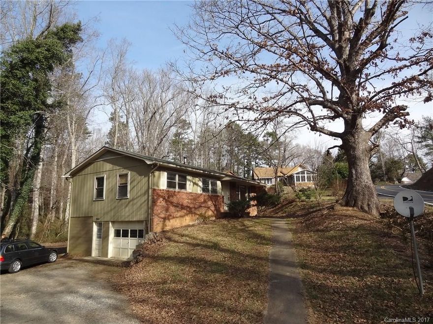 This Ranch Home in Haw Creek, in great condition, sits on a beautiful private lot with a majestic 200 year old oak tree. The .43 acre lot allows for a large garden area along the creek in the private back yard. The home has hardwood oak floors throughout, a new kitchen with granite counters, and a recent heat pump with AC. There is a full daylight basement with drive-in access.  This home and great community is located just 5 minutes east of Downtown Asheville.