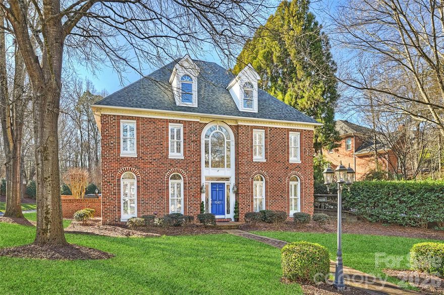 Privately gated and thoughtfully designed, this all-brick Colony Road residence offers a rare combination of privacy, security, and architectural presence in the heart of SouthPark. Now offered at $1,299,999, it presents a compelling opportunity along one of Charlotte’s most established corridors.

Designed for lock-and-leave living, the home features generous interior spaces and a fully enclosed private courtyard that functions as a true extension of the living area.

Hardwood floors span the main level, complemented by fresh interior paint and timeless finishes throughout. Formal living and dining rooms provide elegant, well-proportioned spaces, while the family room features custom built-ins, a gas fireplace, wet bar, and direct courtyard access—creating a seamless indoor-outdoor connection.

The updated kitchen is anchored by a substantial island and includes stainless steel appliances, tile backsplash, and sun-filled windows. A striking central staircase adds architectural presence, while a secondary rear staircase enhances flow and functionality throughout the home.

Upstairs, two spacious primary suites offer exceptional flexibility—one ideal as a guest retreat, bonus room, or office—along with two additional bedrooms connected by a Jack-and-Jill bath. The main primary suite features a luxuriously renovated bath designed for a refined daily experience.

The outdoor setting is further enhanced by a stately brick perimeter wall and a deeper rear yard, creating distinct spaces for entertaining, relaxation, and added privacy.

Recent improvements provide meaningful peace of mind and include a new roof, two new HVAC systems, and refreshed exterior trim and woodwork—helping make ownership simple and low-maintenance.

For buyers prioritizing location, privacy, and ease of ownership in SouthPark, this home presents a differentiated opportunity.