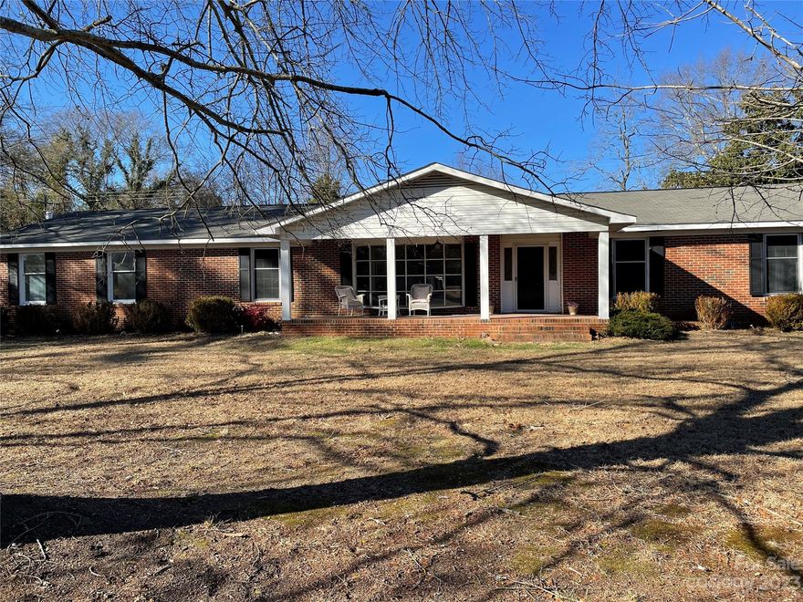 This home sits on a large lot with an outbuilding. The attached carport is a large double. The home includes a formal dining room, office, sitting room in the owner's suite, sunroom off the family room, wood-burning fireplace, and a formal living room.