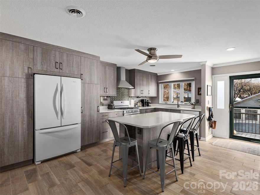 Motivated Seller. All reasonable offers considered. Some furniture available for sale in separate agreement. Perfectly redesigned, this very special condo will appeal to anyone who likes an open floorplan and meticulous attention to detail. A split bedroom plan provides privacy plus updated bathrooms in each suite. The floors are all hard surface, tastefully installed with light wood or matching contemporary tile. The gourmet kitchen features pullout shelves and pantry, soft pull drawers and a console along one wall for extra storage and entertaining. Whirlpool Gold series appliances were chosen. Don’t forget the large screened-in back porch with a hanging bed where naps are mandatory. Close to the forest and away from the street you can’t help but relax. A separate deeded garage offers plenty of additional storage and a safe place for your vehicle out of the weather. This home is conveniently located less than 2 miles from historic downtown Hendersonville, Pardee Hospital and major roadways. Don’t miss out on an a beautiful, affordable home in the fast growing community of Hendersonville.