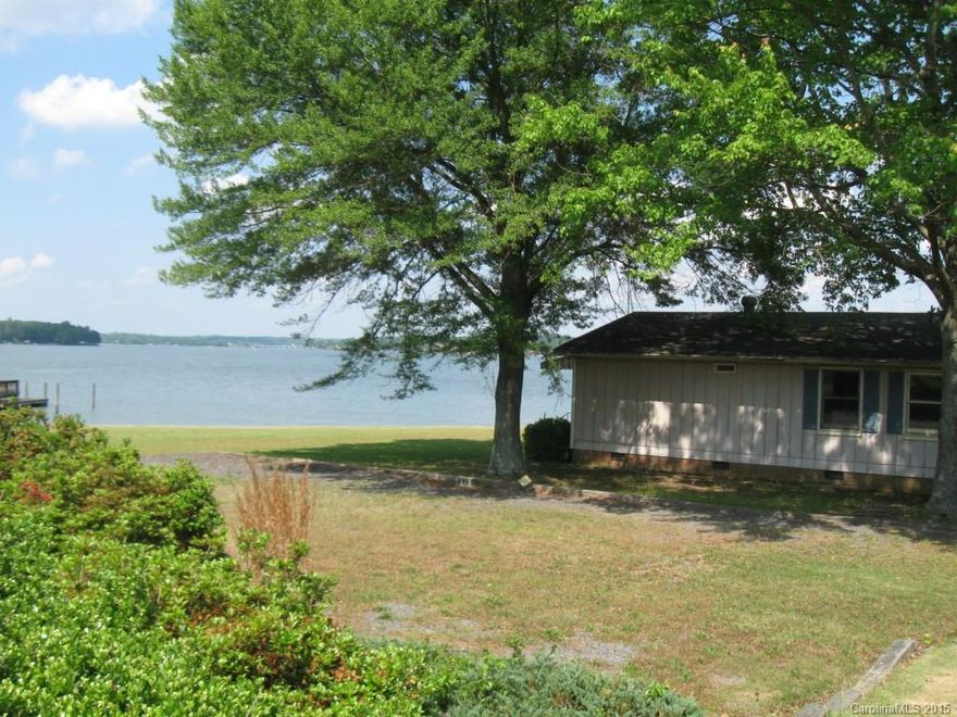 Rare opportunity to own a one & a half acre waterfront lot on the Main Channel of Lake Wylie! Seawall, private boat ramp and dock w/lift in place. This is one of the most beautiful lots on the lake with miles of view. Very level lot. Features a full stack-block and rip rap seawall. The value is in the lot and the house is sold AS-IS although it appears sound.