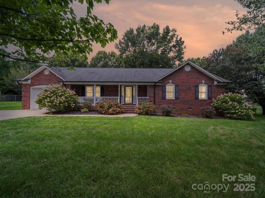 Nestled at 4505 Varner Dr, this charming 3-bed, 2-bath brick home beckons you in with its welcoming front porch and warm  laminate wood floors throughout. Picture yourself cooking at the expansive center island equipped with a stove, while guests relax nearby in the open-plan kitchen/ great room. Step outside to the serene fenced backyard featuring a brick-walled patio and a cozy fire pit—perfect for evening gatherings under the stars. The single-car garage adds convenience and storage, making daily life effortless.
Located in Monroe—a city with a “small-town feel” yet rich in amenities—this home offers quick access to neighborhood parks , and to family-friendly spots such as the Monroe Aquatics & Fitness Center and the Monroe Country Club. Shopping and dining are just minutes away with convenience to Matthews and Monroe.

Call now to schedule a viewing and feel the warm embrace of Monroe living in person!