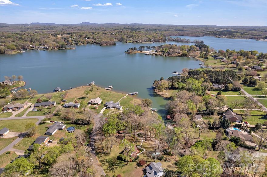 MOSS LAKE WATERFRONT Built in 1980 this home is still owned by the family that built it.
The lot is just shy of one acre, with approximately 220 feet of waterfront. Currently the water is about 3 ft deep at the concrete pier and is typically 5-7 feet deep towards the middle of the cove.
The great news is that there is NO homeowner’s association, so no monthly HOA dues or known restrictions.  It is a 1 1/2 story basement home with 3 bedrooms, 3 full baths and  total heated living area just over 3,300 sq. ft. You’ll enjoy the 2-car detached garage with a large 2nd floor storage room and newly installed sidewalks that give you easy access to the home from the roundabout at the end of the driveway.
The main level includes the primary bedroom with attached bath, kitchen, dining room and a spacious living room that boasts cathedral ceilings, a 2-story, stone fireplace and spectacular 2-story windows w/sliding glass doors that access the wraparound deck. 
Additional features include: a second story with 2 additional bedrooms, a finished basement with a second kitchen, 2 rooms that have been utilized as bedrooms, and a family room with a fireplace. Two separate HVAC systems and a Tri-fuel WEN generator.
Outside you can enjoy lake living at its best. From the large wraparound deck, patio off the basement, and lake views.
BUYER AGENTS ARE WELCOME!