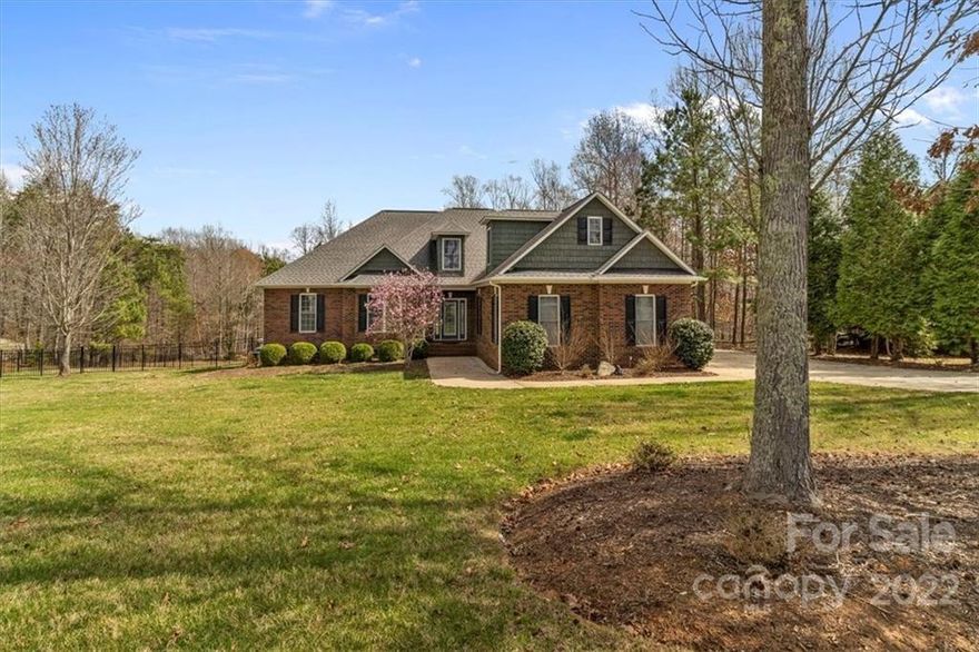 5638 Lake Wylie Road is a rare opportunity to own a 2.37 acre canoe lot in the heart of Lake Wylie. This beautiful custom built brick home offers 2 primary bedrooms. In addition to the secondary bedroom on the main floor there is also an office which the current owner uses as a bedroom. You will enjoy the open floorplan, beautiful hardwood floors, tray ceilings, and many other custom features. Enjoy the private deck overlooking the expansive backyard. Lot is not dockable but offers the perfect place to launch a canoe or stand up paddleboard. Enjoy your own nature trail that wonders through a canopy of mature hardwood trees and ends up by the lake. This is a truly unique offering that won't last long.