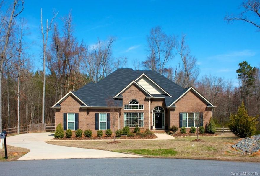 Privacy abounds in this wonderful all brick custom home. Relax on your deck and enjoy the scenes of wildlife in the wooded acerage that backs up to the fenced back yard. Home has soaring ceilings with formal dining, open large great room. Custom kitchen cabinets with ceramic backsplash and silestone countertops. Built in desk area. Split bedroom plan. Home has 4 bedrooms with master featuring trey ceiling. Luxury master bath, with  ceramic tile and beautiful vanities. Very convenient location!