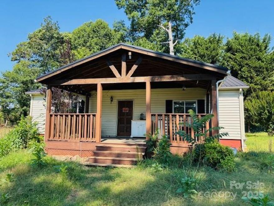 DIAMOND IN THE RUFF looking for a Buyer! Being sold CASH AS-IS. 2BD/1BA Ranch on .71 acres that offers you privacy, and  is fenced. Covered front porch welcomes you inside to a family room, and the kitchen is open to the dining area with a FP. The laundry area is to the left of the kitchen with shelving. Primary bedroom and 2nd. bedroom with a full bath that has a tub/shower. Detached metal carport has been turned into an outbuilding. There is a dog lot in the back right corner of the property. It is on Ellenboro city water and sewer services which also provide weekly trash and recycle pick ups. Convenient to shopping, restaurants, and US 74! Schedule your appointment soon!