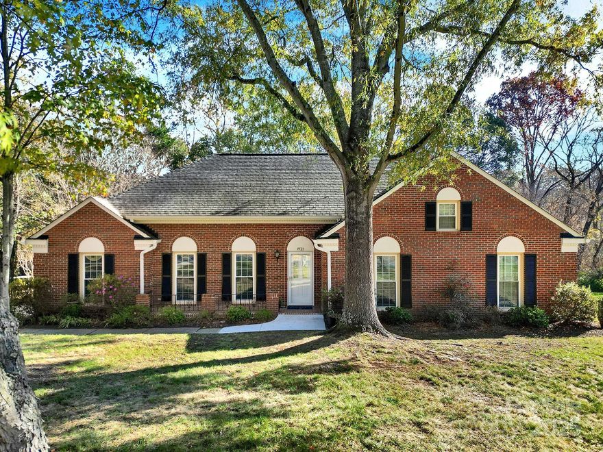 Welcome home to this classic all-brick 4-bedroom, 2-bath ranch with a welcoming southern-style front porch! Featuring a fantastic floor plan and generously sized rooms, this home blends timeless character with modern updates. Enjoy newer carpet and fresh paint throughout. The beautifully updated kitchen boasts white cabinetry, soft-close drawers, roll-out shelving, quartz countertops, a stylish tile backsplash, a pantry, and a cozy eat-in breakfast area. The inviting family room features a natural gas log fireplace—perfect for relaxing evenings. Large windows in the living and dining rooms fill the home with abundant natural light. A spacious laundry/mudroom adds everyday convenience. The primary suite offers a stunning, fully renovated bathroom, while three additional bedrooms and another full bath provide plenty of room for family or guests. Step outside to a peaceful backyard complete with a deck for outdoor entertaining and a locked storage area. The property backs up to a small creek, with Four Mile Creek Greenway just beyond the tree line—creating a serene and natural retreat right at home. You can even take the Greenway to Ballantyne Bowl or Stonecrest, making it an ideal choice for those seeking a vibrant, connected community lifestyle.