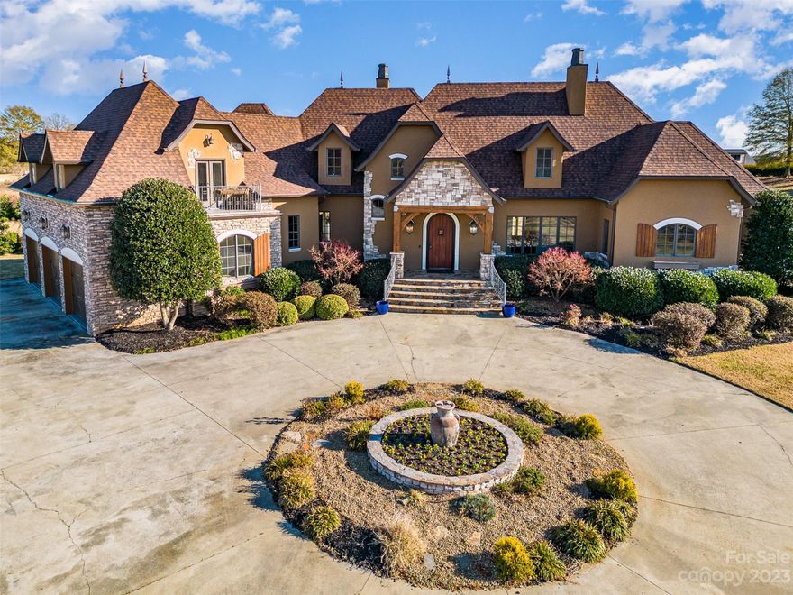 Welcome to a life of refinement & exclusivity. Discover luxury living in this custom home nestled in an exclusive gated community with just 12 homesites on over 50+ acres. The old-world charm is evident in the hard stucco and stone exterior, complemented by a circular drive & a 3-bay garage. Step inside to find 2 primary ensuites, one on each level. Main level ensuite offers a double-sided fireplace shared with private home office. Another see-through fireplace is in the cozy keeping room & kitchen. Kitchen is a chef's dream with high-end appliances, ample cabinetry, oversized eat-in island & a walk-in pantry complete with a desk. Outdoor enthusiasts will love the covered kitchen and entertaining space featuring a grill & wood burning fireplace. Unwind in the oversized recreation room with a wet bar, pool table & private balcony. Two laundry rooms for added convenience. This home epitomizes luxury & comfort. Don't miss your chance to own a slice of paradise in this serene community.