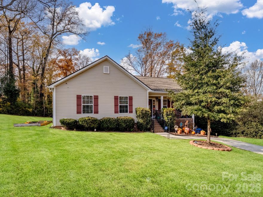 This charming ranch-style home offers modern upgrades and a convenient location. The vaulted ceiling in the living room creates a spacious feel and leads seamlessly into the sunny dining area. The inviting country kitchen features granite countertops, stainless steel appliances, double sinks, and white cabinets, with the refrigerator included. A nice-sized laundry room adds functionality, while the bathrooms are beautifully finished with granite countertops and tile flooring. The primary suite boasts a tray ceiling, walk-in closet, and double-sink vanity, providing comfort and style. Laminate wood flooring throughout the main living areas offers easy maintenance, while carpeted bedrooms add warmth and comfort. Additional highlights include a large attic for ample storage, a welcoming front porch, and a back deck perfect for relaxing or entertaining outdoors. Located just minutes from the highway, Northside Recreation Center, Winthrop University, and shopping centers, this home combines charm and convenience.