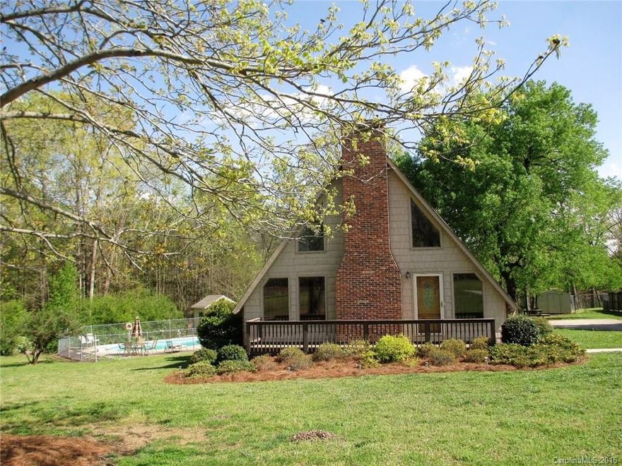 Beautiful contemporary A-frame on landscaped lot all ready for the summer with in-ground pool , pool house and outdoor furniture. Home offers kitchen with lots of storage space and pantry, living room has fireplace with gas logs but no gas line connection. Master on main and 2 bedrooms up with entrance from one onto 2-story deck that offers fantastic view of backyard and neighboring pond.